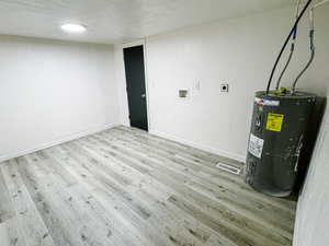 Interior space featuring visible vents and water heater