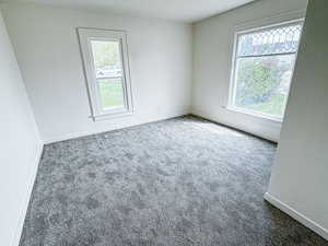 Empty room with baseboards and carpet floors