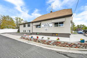 View of front of property featuring fence and a chimney