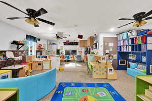 Recreation room with recessed lighting, a ceiling fan, and a textured ceiling
