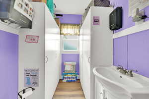 Bathroom featuring wood finished floors and vanity