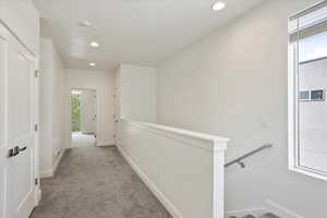 Corridor featuring baseboards, recessed lighting, an upstairs landing, and carpet floors