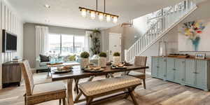 Dining room featuring recessed lighting, stairs, light wood-style flooring, and baseboards