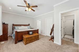Bedroom with crown molding, recessed lighting, light colored carpet, ceiling fan, and baseboards