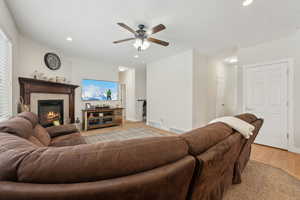 Living room featuring a fireplace, visible vents, and recessed lighting