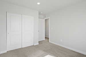 Unfurnished bedroom featuring visible vents, carpet floors, baseboards, a closet, and recessed lighting