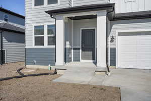 Doorway to property with a garage
