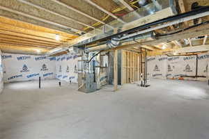 Unfinished below grade area featuring heating unit