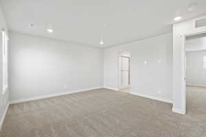 Empty room with light colored carpet, recessed lighting, baseboards, and visible vents