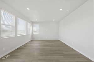Spare room with visible vents, recessed lighting, light wood-style flooring, and baseboards