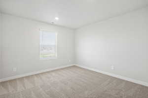 Carpeted empty room featuring baseboards, recessed lighting, and visible vents