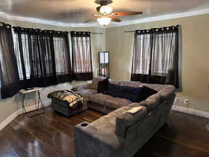 Living area featuring ornamental molding, a ceiling fan, wood finished floors, and baseboards