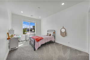 Bedroom with carpet floors, baseboards, recessed lighting, and visible vents