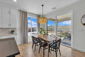 Dining area featuring recessed lighting, baseboards, visible vents, and light wood-style flooring