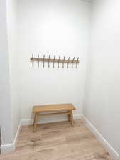 Mudroom with baseboards and light wood-style flooring