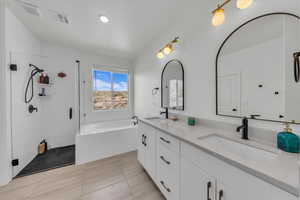Full bathroom featuring walk in shower, a sink, double vanity, visible vents, and a garden tub