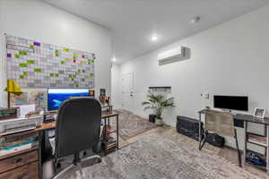 Office area featuring baseboards, a wall mounted AC, recessed lighting, and wood finished floors