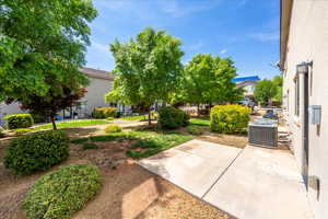 View of yard featuring cooling unit and a patio area