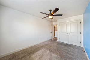 Unfurnished bedroom featuring a closet, carpet flooring, and baseboards