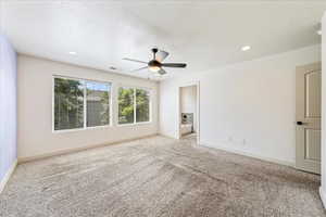 Unfurnished room with baseboards, visible vents, a ceiling fan, and carpet flooring