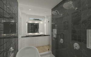Bathroom featuring double vanity, tile walls, a wet room with shower, soaker tub, and a sink