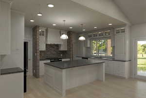 Kitchen with a sink, decorative backsplash, glass insert cabinets, custom range hood, and light wood-style flooring
