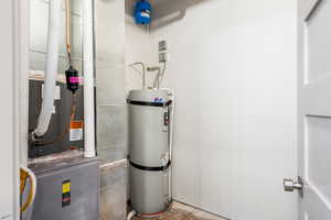 Utilities featuring strapped water heater and propane furnace