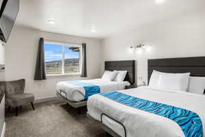 Bedroom 1 with 2 queen beds, fireplace and TV