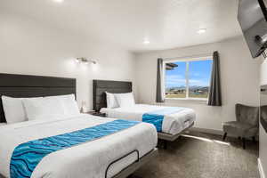 Bedroom 3 featuring 2 queen size beds, electric fireplace and TV