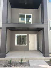 View of exterior entry with stucco siding