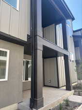 View of side of property featuring board and batten siding and stucco siding
