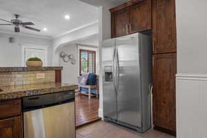 Kitchen featuring appliances with stainless steel finishes, ornamental molding, a ceiling fan, light tile patterned floors, and dark brown cabinetry