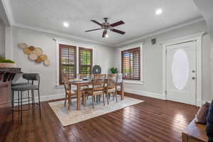 Dining room featuring ceiling fan, hardwood / wood-style floors, baseboards, recessed lighting, and crown molding