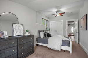 Bedroom with light colored carpet, a closet, baseboards, and ceiling fan