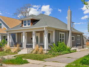 Bungalow-style home featuring a chimney, board and batten siding, a porch, and a shingled roof