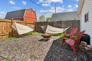 View of yard featuring a fire pit and a fenced backyard