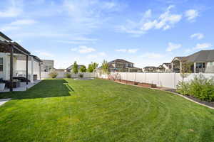 View of yard featuring a pergola, a patio area, a residential view, and a fenced backyard