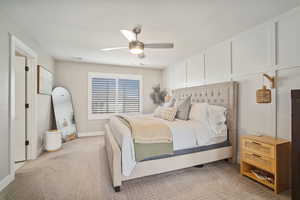 Bedroom featuring baseboards, visible vents, ceiling fan, and light colored carpet