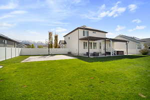 Back of house featuring a pergola, a patio, and a fenced backyard