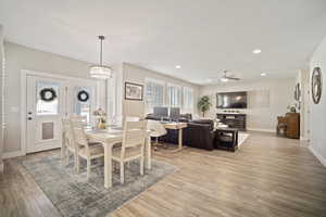 Dining space with recessed lighting, ceiling fan, light wood-style flooring, and baseboards