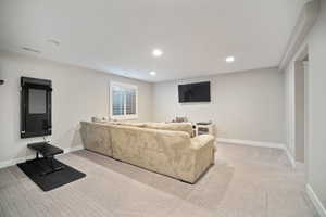 Living area with visible vents, baseboards, recessed lighting, and carpet floors