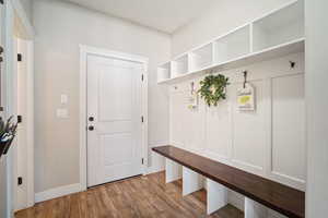 Mudroom with baseboards and wood finished floors