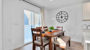 Dining space featuring light wood finished floors and baseboards