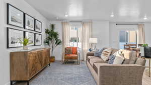 Living area featuring a textured ceiling and recessed lighting