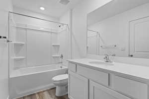 Full bathroom featuring vanity, shower / bathing tub combination, toilet, visible vents, and wood finished floors