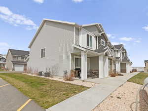 View of home's exterior with a lawn, cooling unit, and a residential view