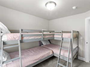 Bedroom featuring baseboards and carpet floors