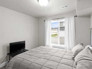 Bedroom with baseboards and visible vents