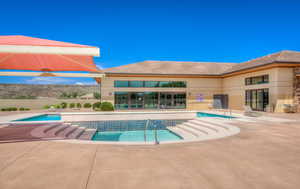Pool featuring fence and a patio area