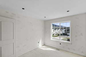 Spare room with baseboards and visible vents